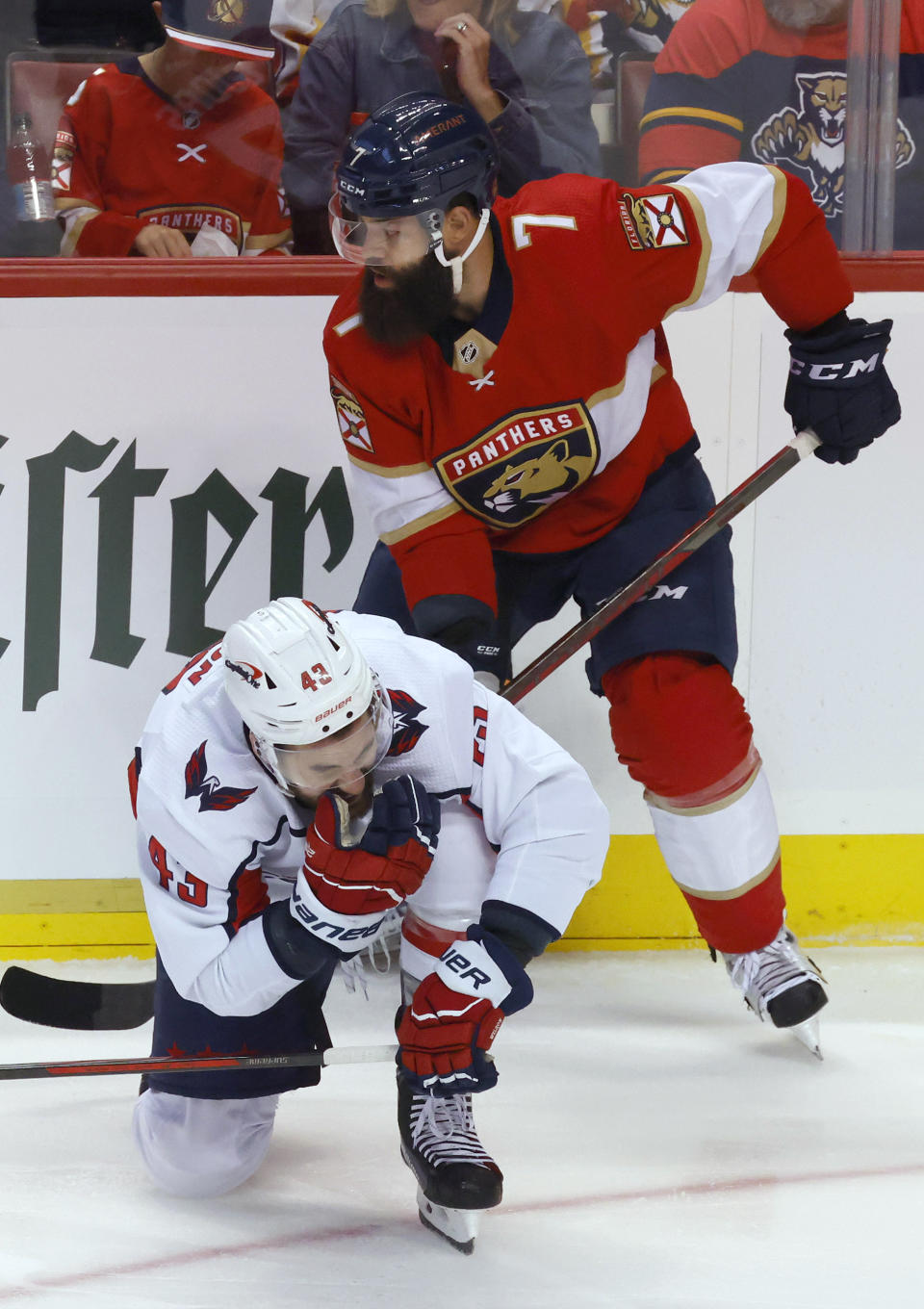 Washington Capitals right wing Tom Wilson (43) reacts after getting a high stick to the face from Florida Panthers defenseman Radko Gudas (7) during the first period of Game 1 of an NHL hockey first-round playoff series Tuesday, May 3, 2022, in Sunrise, Fla. (AP Photo/Reinhold Matay)