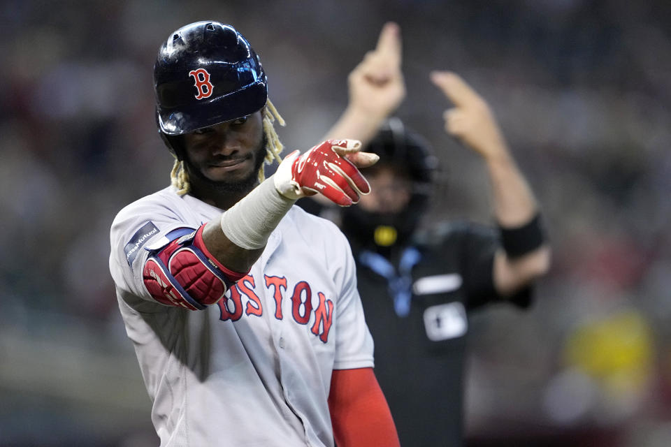 Boston Red Sox center fielder Raimel Tapia motions to his bench to review a call during the first inning of a baseball game against the Arizona Diamondbacks, Saturday, May 27, 2023, in Phoenix. (AP Photo/Matt York)