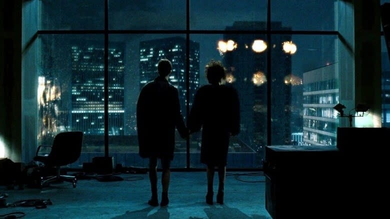 Edward Norton as The Narrator and Helena Bonham Carter as Marla hold hands and watch fireworks out a window at the end of 'Fight Club'