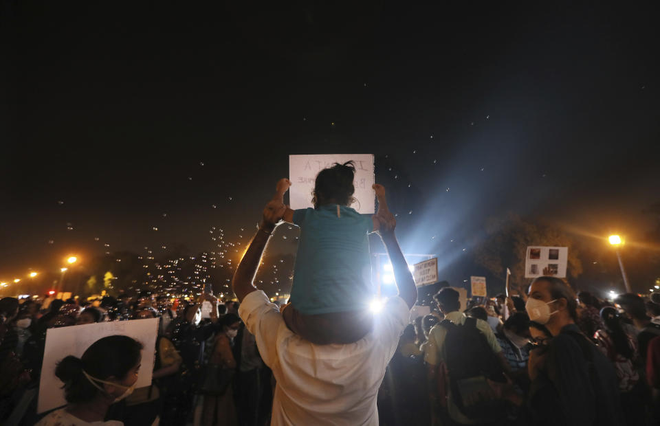 An Indian carries a child on his shoulder and participates in a protest against the alarming levels of pollution in the city, near the India Gate monument in New Delhi, India, Tuesday, Nov. 5, 2019. The 20 million residents of New Delhi, already one of the world's most polluted cities, have been suffering for weeks under a toxic haze that is up to 10 times worse than the upper limits of what is considered healthy. The pollution crisis is piling public pressure on the government to tackle the root causes of the persistent haze. (AP Photo/Manish Swarup)