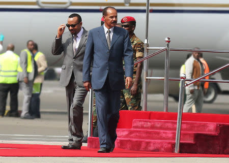 Eritrea's President Isaias Afwerki is welcomed by Ethiopian Prime Minister Abiy Ahmed upon arriving for a three-day visit, at the Bole international airport in Addis Ababa, Ethiopia July 14, 2018. REUTERS/Tiksa Negeri