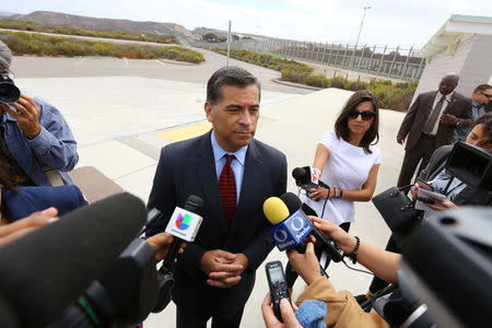 Attorney General of California Xavier Becerra speaks to the media at the U.S.-Mexico border at the Pacific Ocean after announcing a lawsuit against the Trump Administration over its plans to begin construction of border wall in San Diego and Imperial Counties, in San Diego, California, U.S., September 20, 2017. REUTERS/Mike Blake