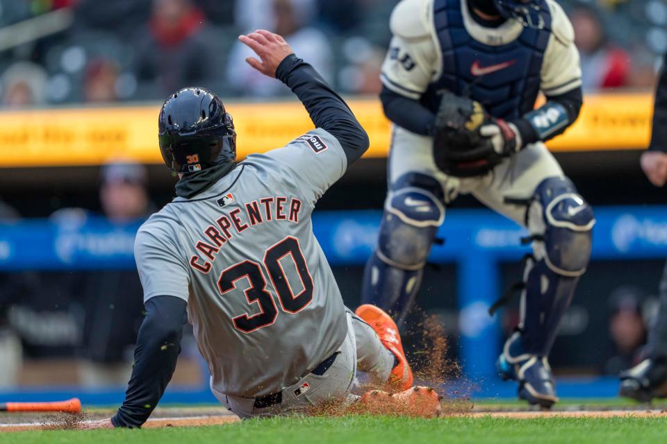 Tigers left fielder Kerry Carpenter slides into home plate for a run against the Twins in the first inning on Friday, April 19, 2024, in Minneapolis.