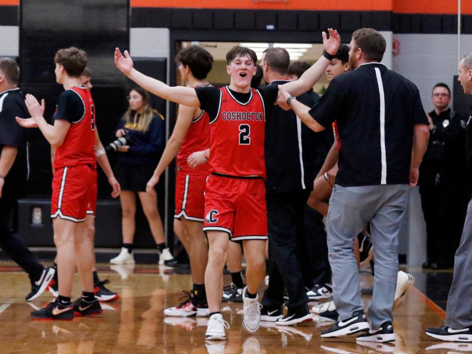 Coshocton junior Colton Conkle celebrates after his team's 61-57 overtime win against host Ridgewood on Wednesday night at the Coshocton County Classic. Conkkle, who scored a game-high 26 points, hit two free throws with 1.2 seconds left in overtime to seal it.
