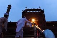 Muslim devotees arrive to offer a special morning prayer to kick off the Eid al-Adha, the feast of sacrifice, at Jama Masjid mosque in New Delhi on August 1, 2020. (Photo by Money SHARMA / AFP) (Photo by MONEY SHARMA/AFP via Getty Images)