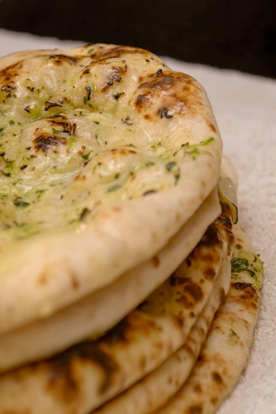 An order of Naan is readied at Cali Tardka home restaurant in Riverside.