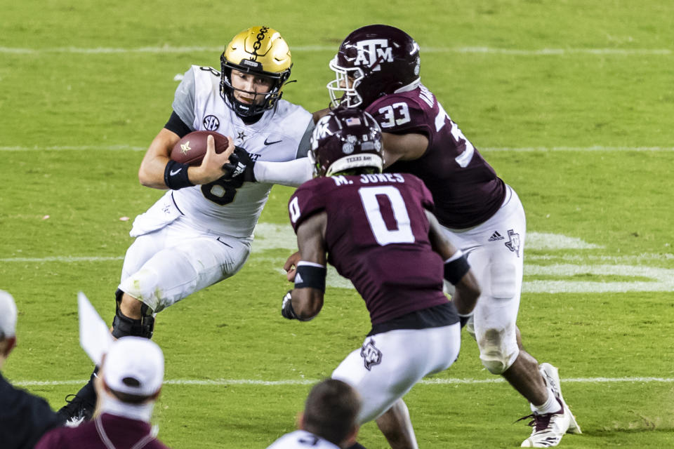 Sep 26, 2020; College Station, Texas; Texas A&M Aggies linebacker Aaron Hansford (33) and defensive back Myles Jones (0) tackle Vanderbilt Commodores quarterback Ken Seals (8) during the fourth quarter at Kyle Field. Maria Lysaker-USA TODAY Sports