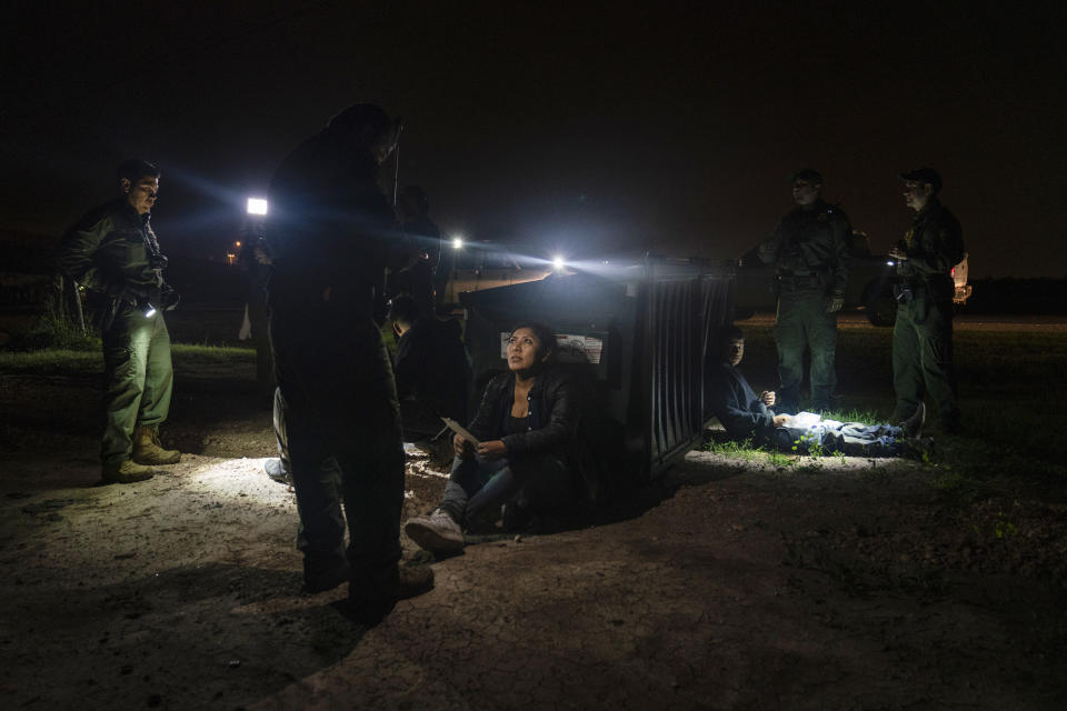 FILE - Migrants that were trying to evade U.S. Border Patrol agents, wait to be processed in Granjeno, Texas, early Thursday, May 4, 2023. A recent surge of migrants in the Brownsville area of the U.S.-Mexico border is highlighting immigration challenges as the U.S. prepares for the end of a policy linked to the coronavirus pandemic that allowed it to quickly expel many migrants. (AP Photo/Veronica G. Cardenas, File)
