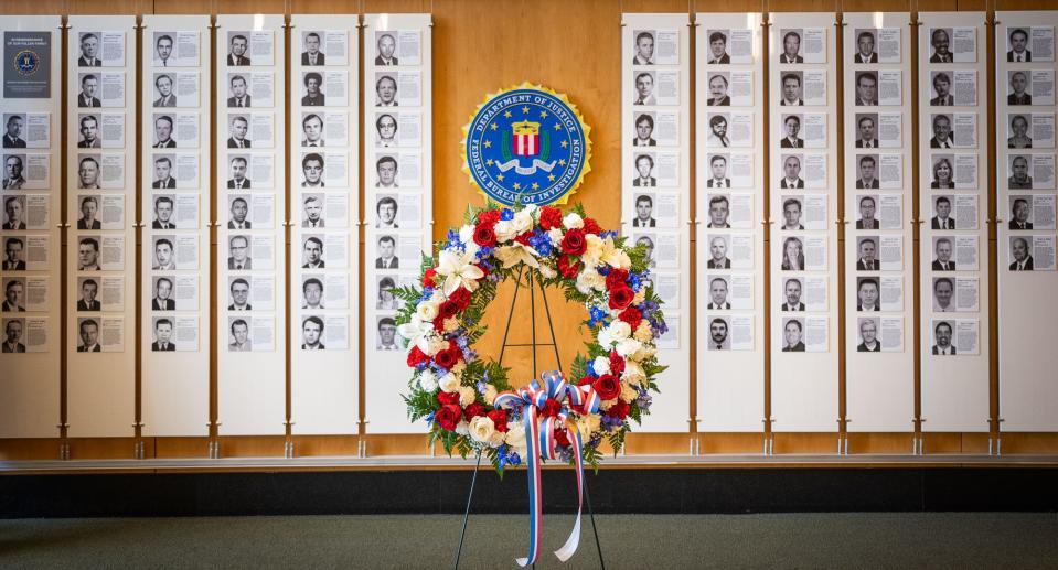 A wreath stands before the Wall of Honor at FBI Jacksonville during National Police Week to pay tribute to the sacrifices of the 92 employees who have died in the line of duty.