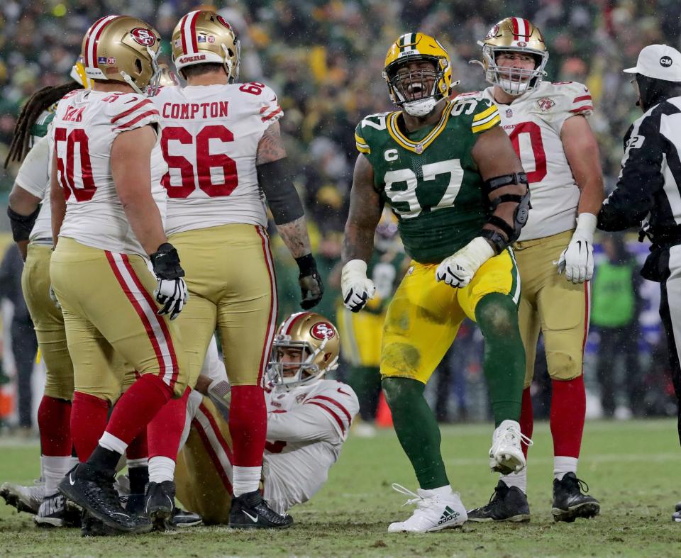 Green Bay Packers nose tackle Kenny Clark (97) celebrates a sack on San Francisco 49ers quarterback Jimmy Garoppolo (10) during the third quarter of the divisional playoff game at Lambeau Field in Green Bay on January 22, 2022.