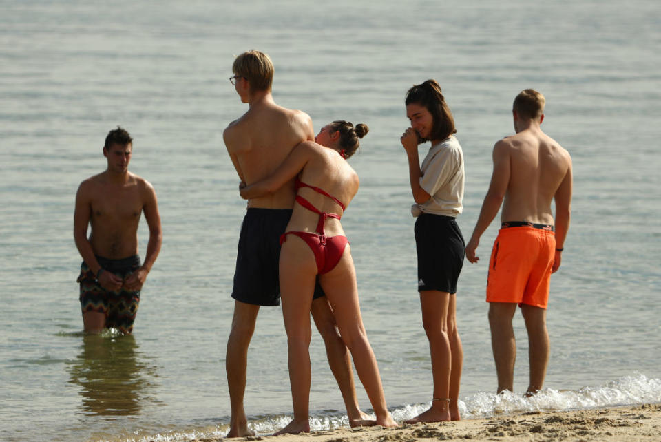 People are seen at St Kilda Beach in Melbourne, Australia. 