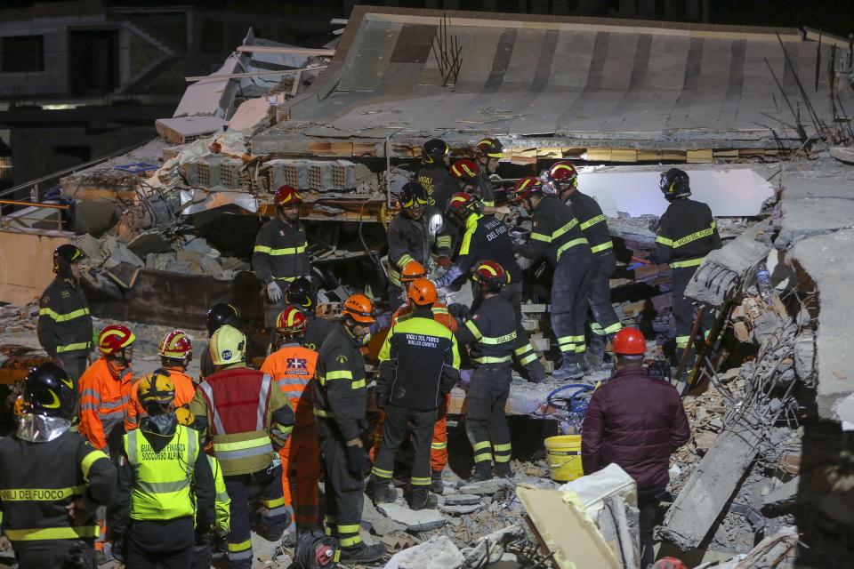 In this photo taken on Wednesday, Nov. 27, 2019, rescuers from Italy and Greece operate at a collapsed building after the 6.4-magnitude earthquake in Durres, western Albania. In the initial hours after a deadly pre-dawn earthquake struck Albania, pancaking buildings and trapping dozens of sleeping people beneath the rubble, the country’s neighbors sprang into action. Offers of help flooded in from across Europe and beyond, with even traditional foes setting aside their differences in the face of the natural disaster. (AP Photo/Visar Kryeziu)