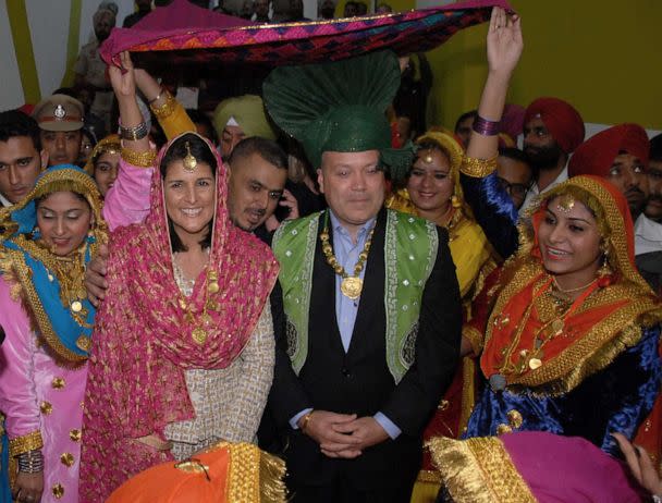 PHOTO: Governor of South Carolina Nikki Haley poses with her husband Michael Haley and traditional Punjabi dancers as she arrives to attend a function at Lovely Professional University LPU in Jalandhar, Nov. 14, 2014. (Shammi Mehra/AFP via Getty Images)