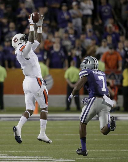 Auburn wide receiver D'haquille Williams (1) gets past Kansas State defensive back Danzel McDaniel (7) to catch a long pass. Thursday, Sept. 18, 2014, in Manhattan, Kan. (AP Photo/Charlie Riedel)