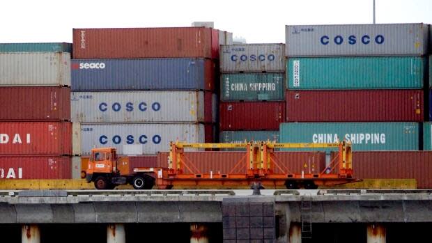 A truck passes by some of the many containers that it tows on a daily basis at Vancouver's port.