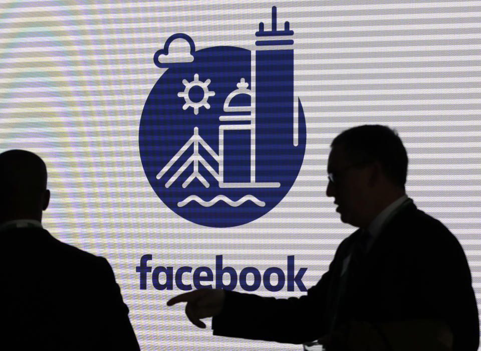 FILE - In this Jan. 9, 2019, file photo, media and guests mingle before a tour of Facebook's new 130,000-square-foot offices, which occupy the top three floors of a 10-story Cambridge, Mass., building. Executives from Google and Facebook are facing Congress Tuesday, April 8, to answer questions about their role in the hate crimes and the rise of white nationalism in the U.S. (AP Photo/Elise Amendola, File)