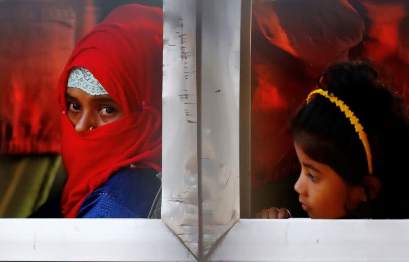 Rohingyas that will be shifted to Bhasan Char island are seen onboard a bus in Chattogram