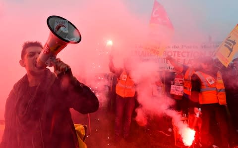 SNCF railway workers hold flares against reform plans on April 9, 2018 - Credit: &nbsp;GERARD JULIEN/AFP