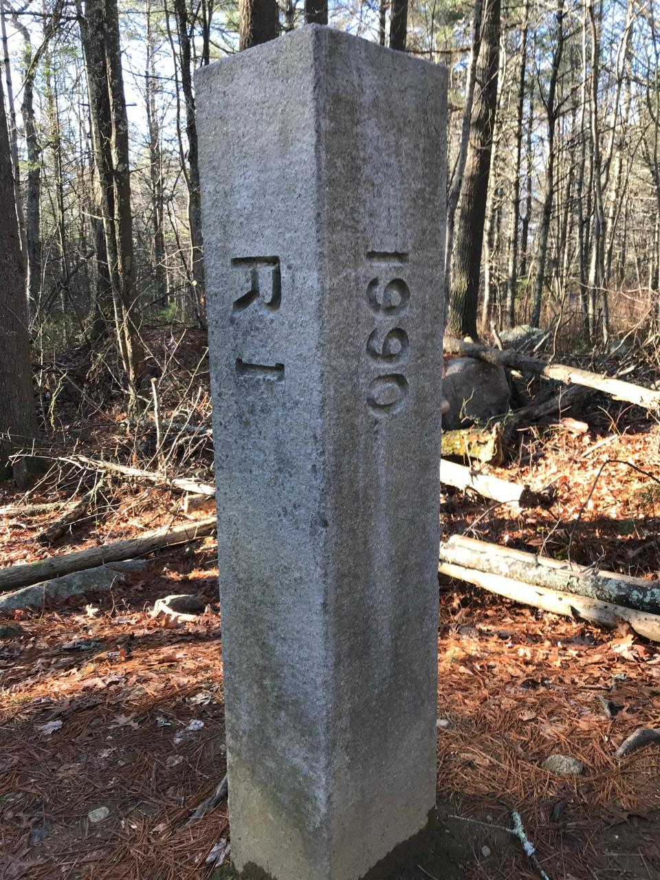 A 5-foot-tall stone pillar marks the trailhead at the Rhode Island/Connecticut border.