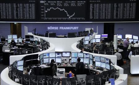 Traders are pictured at their desks in front of the DAX board at the Frankfurt stock exchange November 13, 2014. REUTERS/Remote/Stringer