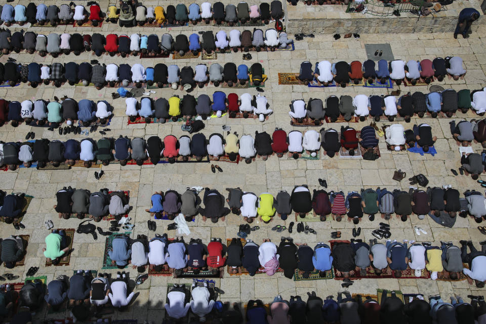 Palestinian worshipers pray during the first Friday of the holy month of Ramadan at the Al Aqsa Mosque compound in Jerusalem's old city, Friday, April. 16, 2021. (AP Photo/Mahmoud Illean)