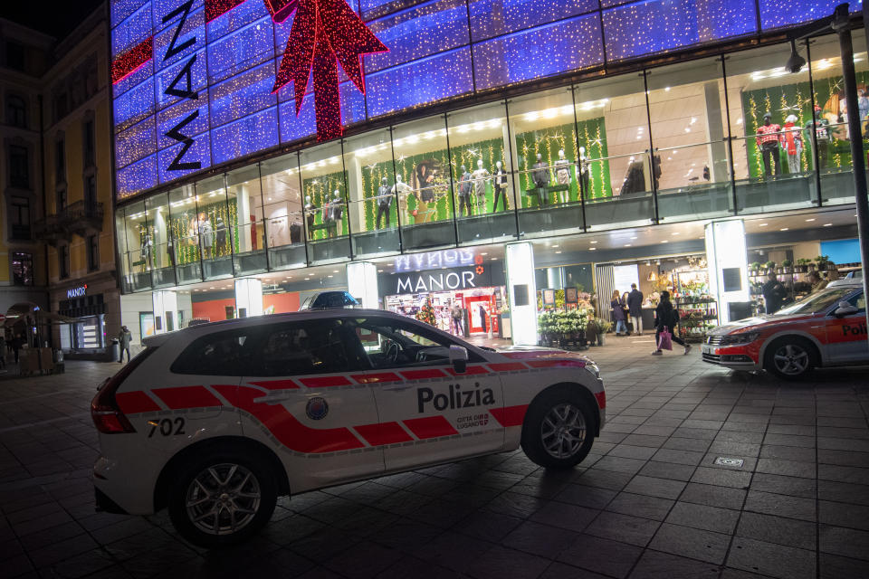 A police car in the area where a stabbing occurred in a department store, in Lugano, Switzerland, Tuesday, Nov. 24, 2020. Swiss authorities are investigating as a possible terror attack the stabbing of two women in an department store in the southern city of Lugano, and a suspect has been arrested. Officials said one of the victims sustained serious but not life-threatening injuries, while the other sustained minor injuries. (Ti-Press/Keystone via AP)