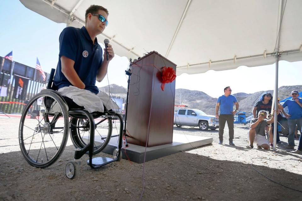 In this 2019 photo, local wounded warrior Brian Kolfage, who lost both legs and his right arm in a rocket attack while serving in Iraq in 2004, speaks in Sunland Park, New Mexico, where a section of U.S-Mexico border wall was built with private donations to We Build The Wall Inc., nonprofit organization he founded. Currently, Kolfage is facing federal trials in New York and Florida in connection with alleged irregularities in the handling of the nonprofit's dollars.