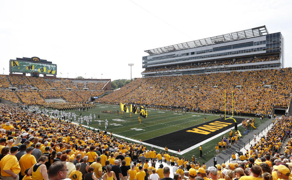 FILE - Fans cheer before an NCAA college football game between Iowa and North Texas at Kinnick Stadium in Iowa City, Iowa, Sept. 16, 2017. The University of Iowa announced 26 of its athletes across five sports are alleged to have participated in sports wagering in violation of NCAA rules. (AP Photo/Charlie Neibergall, File)