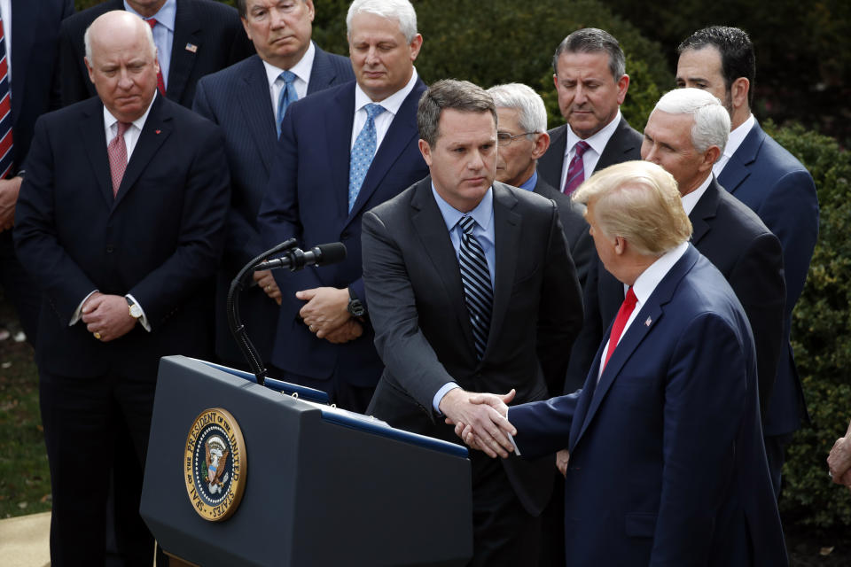 President Donald Trump shakes hands with Doug McMillon, president and CEO of Walmart Inc., during a news conference about the coronavirus on Friday. (Photo: ASSOCIATED PRESS)