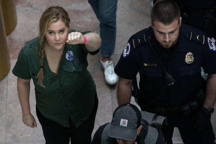 <p>Comedian Amy Schumer (L) is led away after she was arrested during a protest against the confirmation of Supreme Court nominee Judge Brett Kavanaugh October 4, 2018 at the Hart Senate Office Building on Capitol Hill in Washington, DC. Senators had an opportunity to review a new FBI background investigation into accusations of sexual assault against Kavanaugh and Republican leaders are moving to have a vote on his confirmation this weekend. (Photo: Alex Wong/Getty Images) </p>