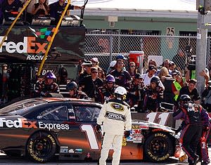 Denny Hamlin's crew works on his car after a spin on Lap 24