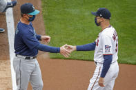 Seattle Mariners manager Scott Servais greets Minnesota Twins manager Rocco Baldelli during the introductions at the home opener baseball game Thursday, April 8, 2021, in Minneapolis. (AP Photo/Bruce Kluckhohn)