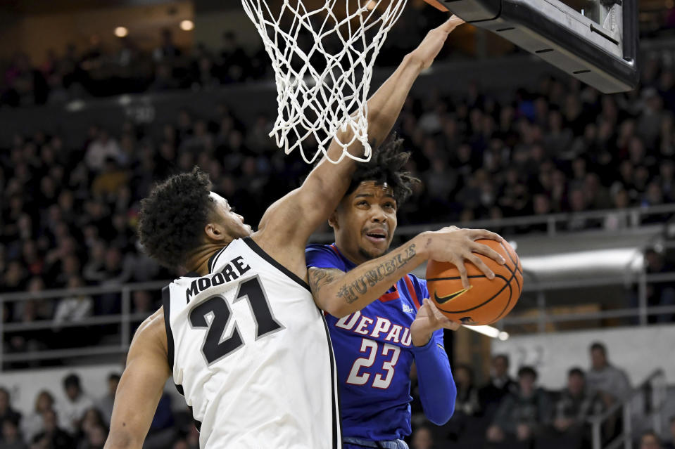 DePaul's Caleb Murphy (23) has his lay-up blocked by Providence's Clifton Moore (21) during the first half of an NCAA college basketball game, Saturday, Jan. 21, 2023, in Providence, R.I. (AP Photo/Mark Stockwell)