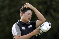 Sungjae Im of South Korea brushes back his hair during the HSBC Champions golf tournament held at the Sheshan International Golf Club in Shanghai on Friday, Nov. 1, 2019. (AP Photo/Ng Han Guan)