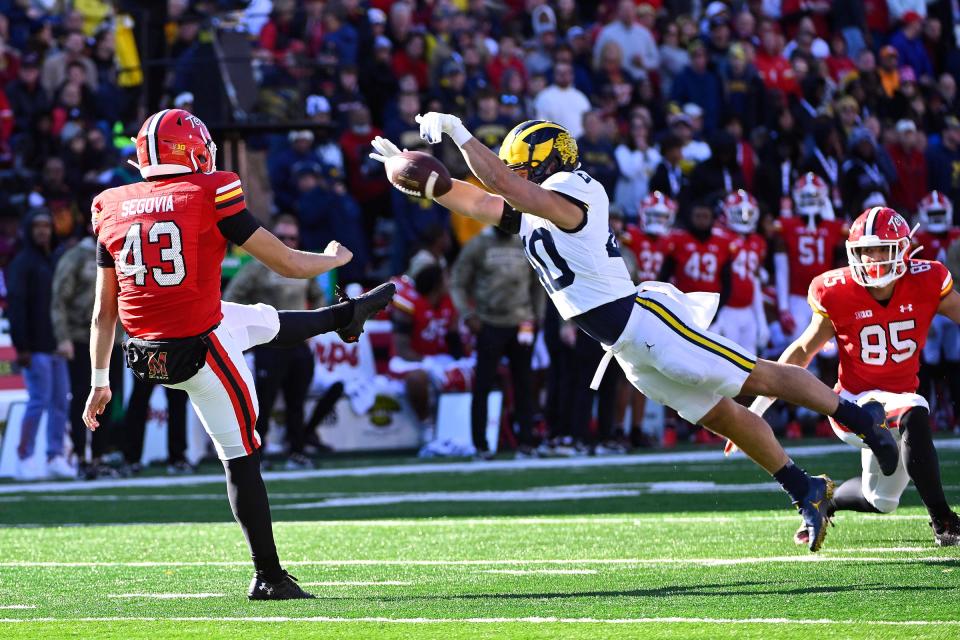 Michigan Wolverines linebacker Christian Boivin blocks the punt of Maryland Terrapins punter Brenden Segovia resulting in a safety during the first half at SECU Stadium in College Park, Maryland, Nov. 18, 2023.