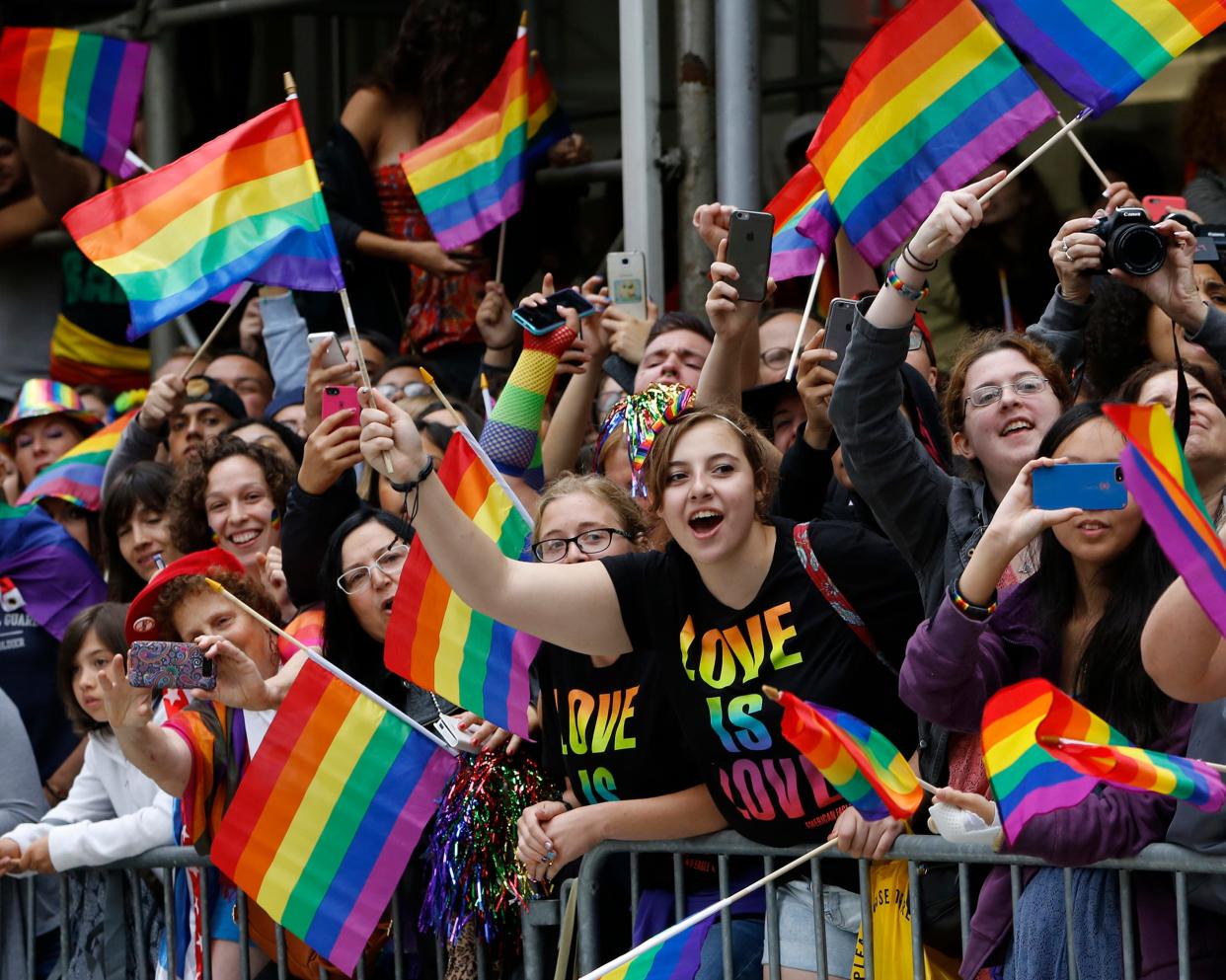 A crowd waves rainbow flags during the Heritage Pride March in New York, June 28, 2015.