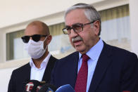 Turkish Cypriot leader and candidate Mustafa Akinci speak to the media after voting at a polling station in the Turkish occupied area in the north part of the divided capital Nicosia, Cyprus, Sunday, Oct. 18, 2020. Turkish Cypriots are voting in a leadership runoff to chose between an incumbent who pledges a course less bound by Turkey’s dictates and a challenger who favors even closer ties to Ankara. (AP Photo/Nedim Enginsoy)