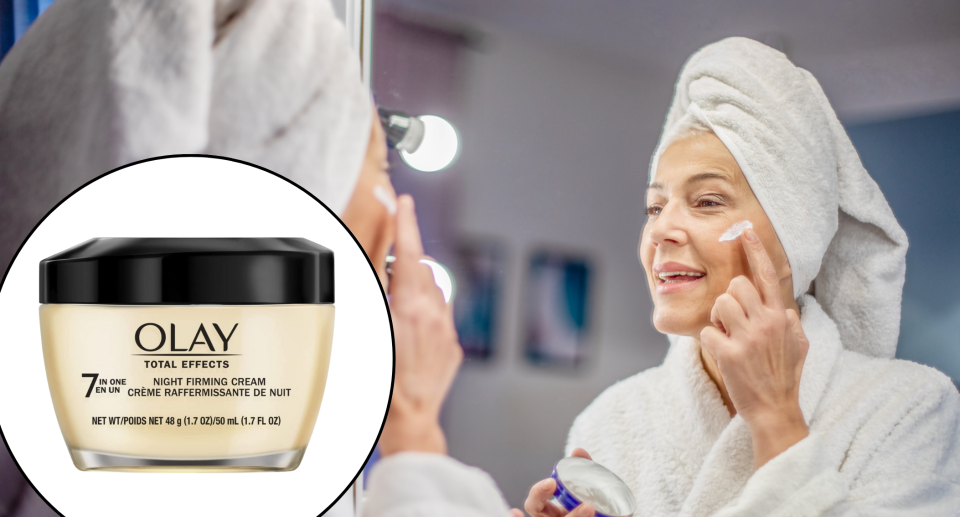 face cream, older woman wearing white towel on head and white bathroom looking in mirror applying face cream, olay total effects 2-in-one anti-aging night cream