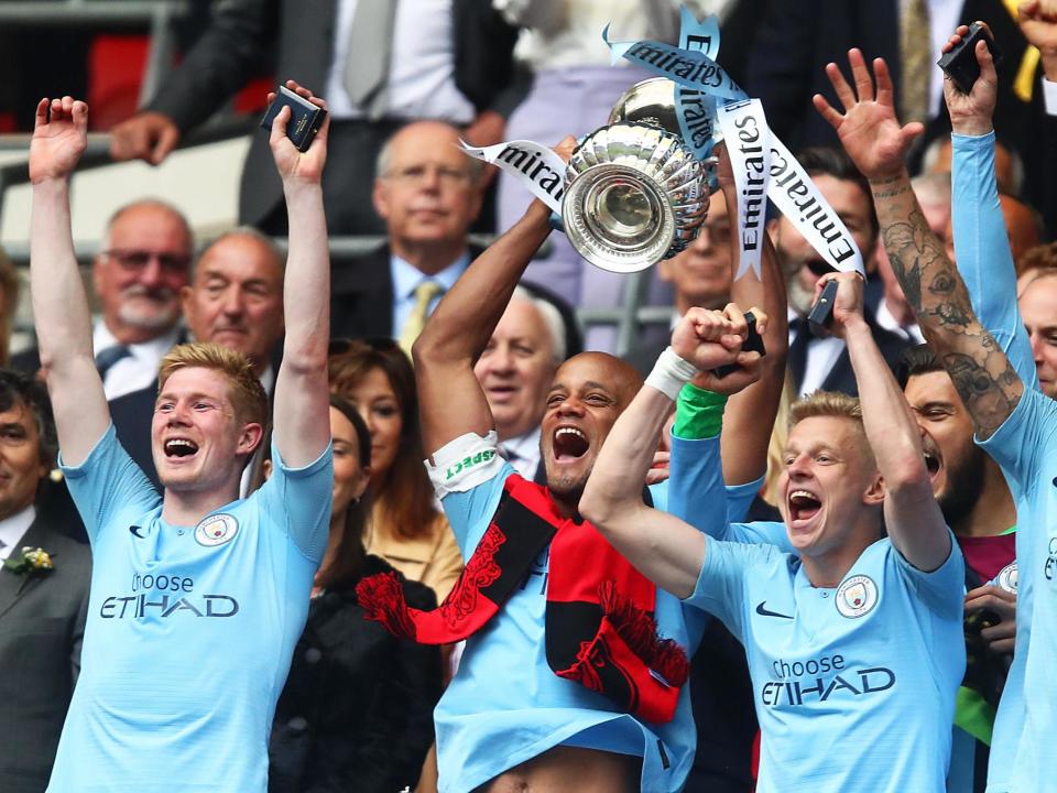 Vincent Kompany of Manchester City lifts the trophy: Getty Images