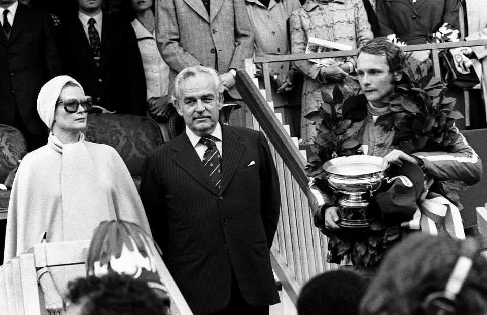 Lauda poses on the podium, along with Princess Grace and Prince Rainier of Monaco, after he won the 33rd Grand Prix of Monaco on May 11th 1975. (Photo by RALPH GATTI/AFP/Getty Images)