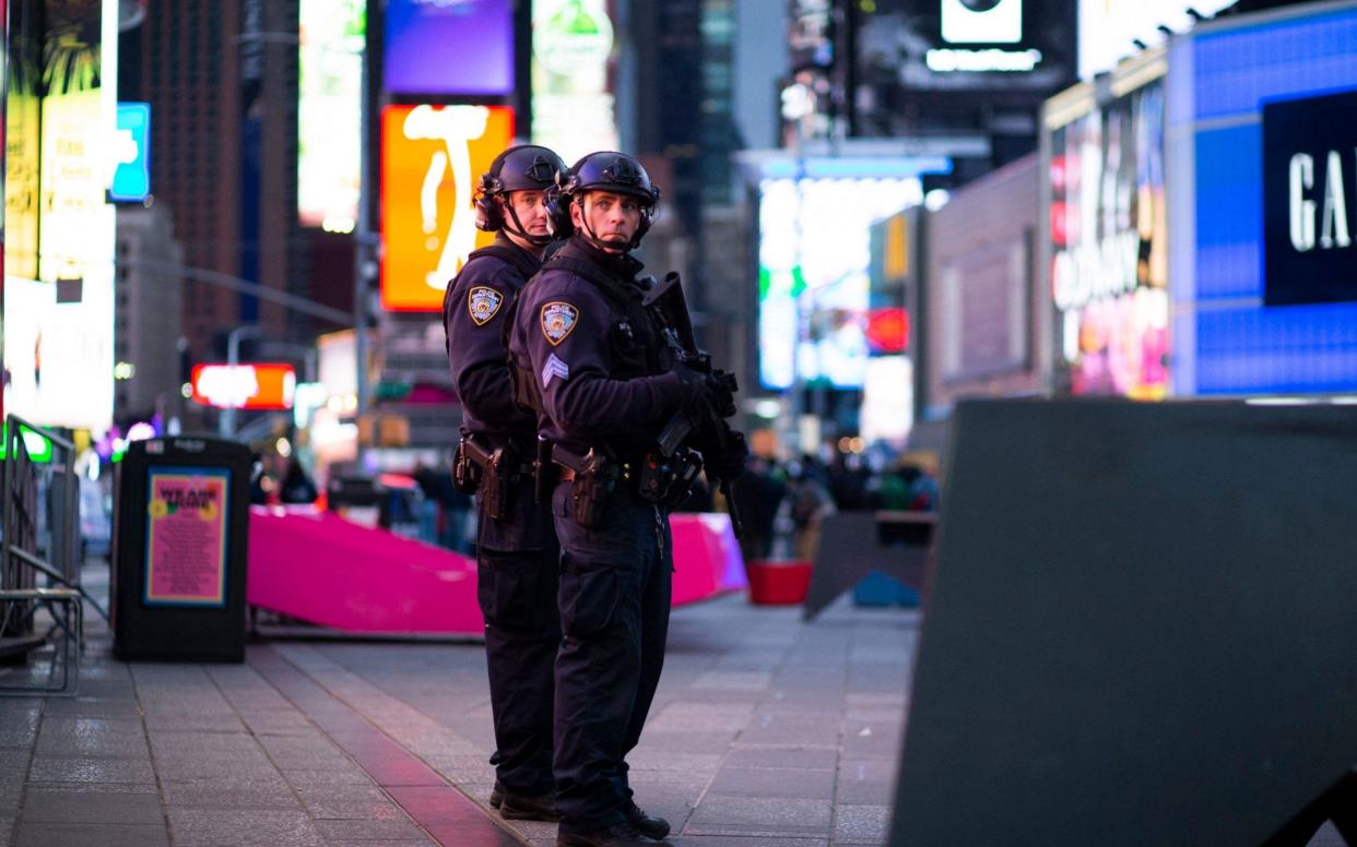 NYPD officers stand guard after two women and a four-year-old girl were injuring by gun fire in Times Square, New York  - AFP