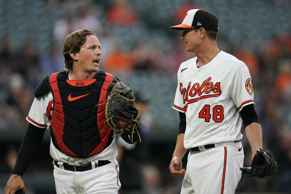 Baltimore Orioles starting pitcher Kyle Gibson (48) talks to catcher Adley Rutschman after pitching to the Cleveland Guardians during the third inning of a baseball game, Tuesday, May 30, 2023, in Baltimore. (AP Photo/Julio Cortez)