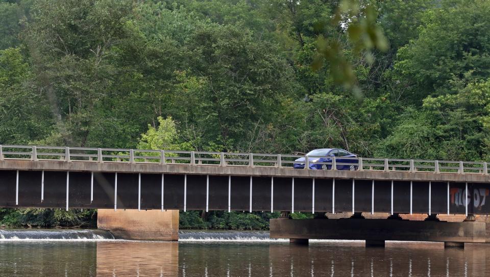 A car crosses over the Armstrong Ford Road dam near Cramerton Thursday morning, August 25, 2022.