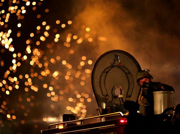 In this Aug. 17, 2014, file photo, a law enforcement officer watches from an armored vehicle during a protest for Michael Brown in Ferguson, Missouri. (Photo: via Associated Press)