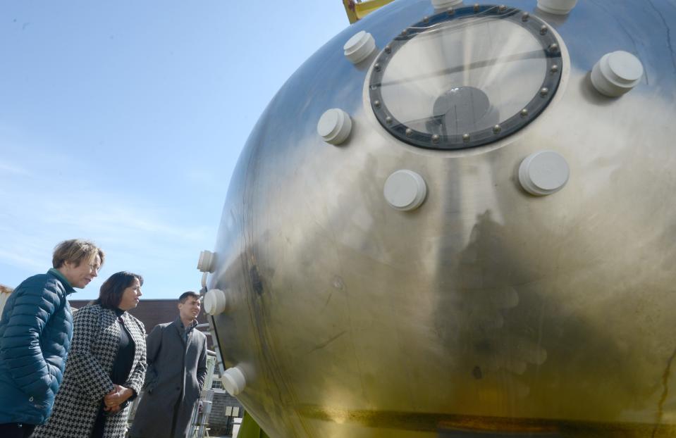 Massachusetts Gov. Maura Healey, left, and Lt. Gov. Kim Driscoll, center, along with state Rep. Dylan Fernandes, D-Woods Hole, take in the sphere from the Alvin submersible during a tour Thursday along the docks of the Woods Hole Oceanographic Institution in Woods Hole.