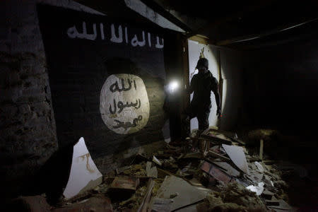 Islamic State slogans painted along the walls of the tunnel was used by Islamic State militants as an underground training camp in the hillside overlooking Mosul, Iraq, March 4, 2017. REUTERS/Alaa Al-Marjani