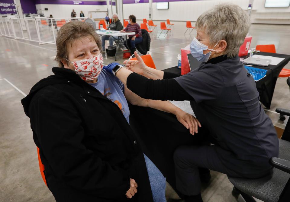 Diana Perryman receives her COVID-19 booster shot from Joan Cisna, a registered nurse with the Springfield-Greene County Health Department, on Friday, Jan. 7, 2022.