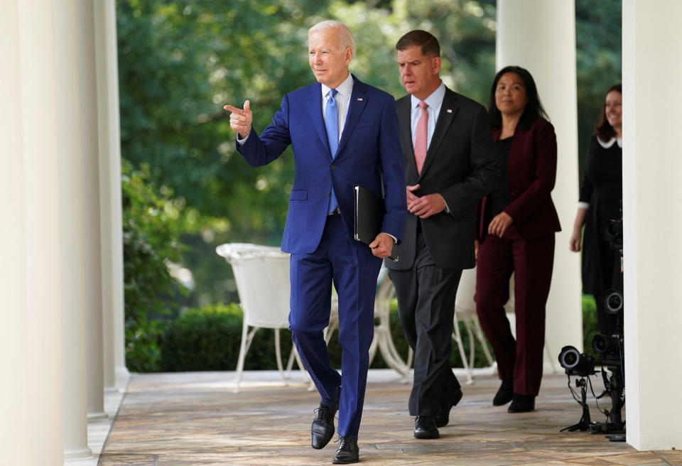 U.S. President Joe Biden is followed by Labor Secretary Marty Walsh and negotiators who brokered the railway labor agreement after U.S. railroads and unions secured a tentative deal to avert a rail shutdown, as he arrives to deliver remarks on the deal in the Rose Garden at the White House in Washington, U.S., September 15, 2022. REUTERS/Kevin Lamarque