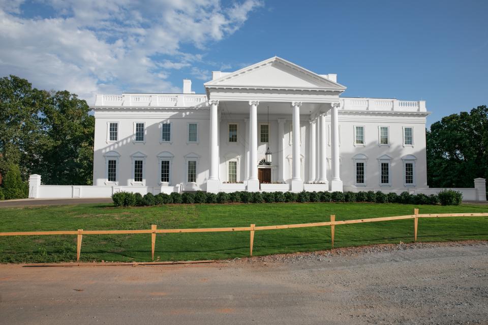 A three-story stucco replica of the White House on the grounds of the production facility.