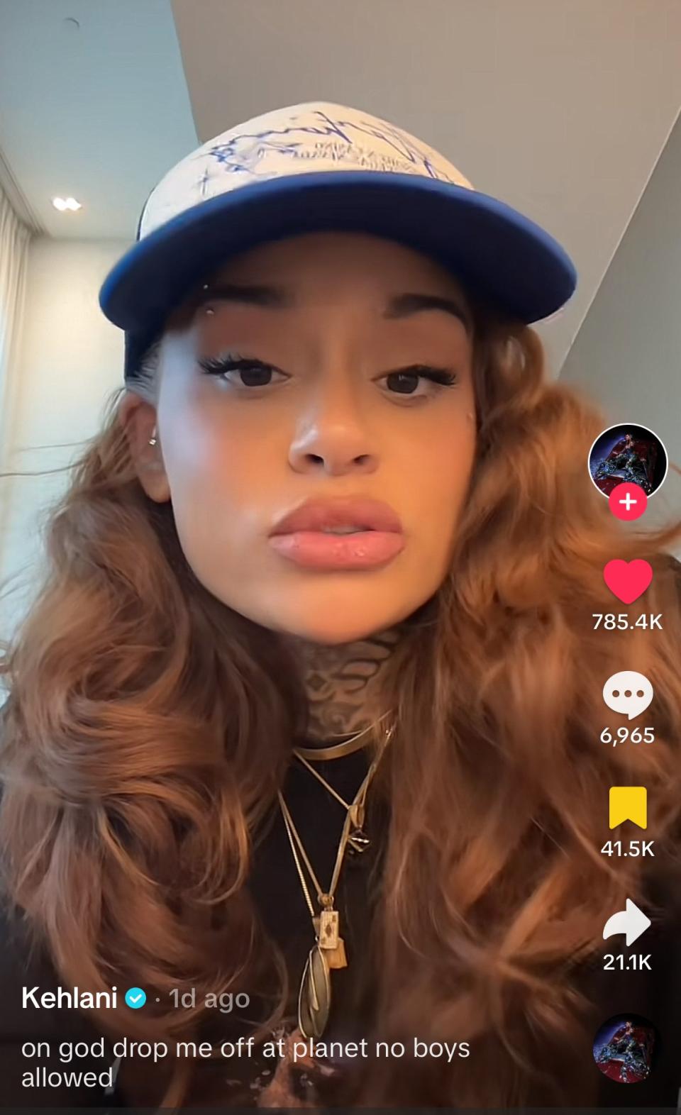 Singer Kehlani wearing a blue and white cap, seen in a TikTok video with the caption, "on god drop me off at planet no boys allowed." The video has 785.4K likes